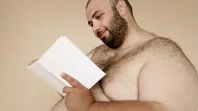 overweight man reading a book