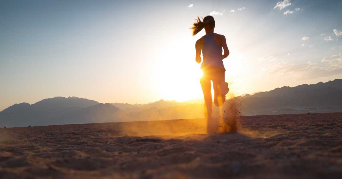 Athlete running at sunrise. Benefits of Running in Cold Weather