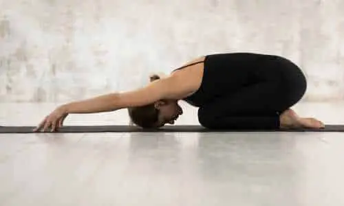 instructor performing the child's pose yoga