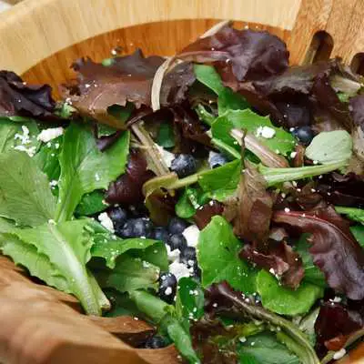 green leafy salad in a wooden bowl
