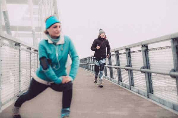 What to wear running 50 degrees? Athletes running across bridge. 