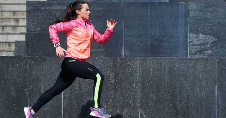 model running down city street. Gaining Weight From Running? Here Are 4 Reasons Why You Could Be Running But Not Losing Weight