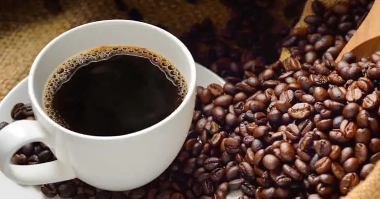 cup of coffee with coffee beans. What is the best time to drink black coffee for weight loss