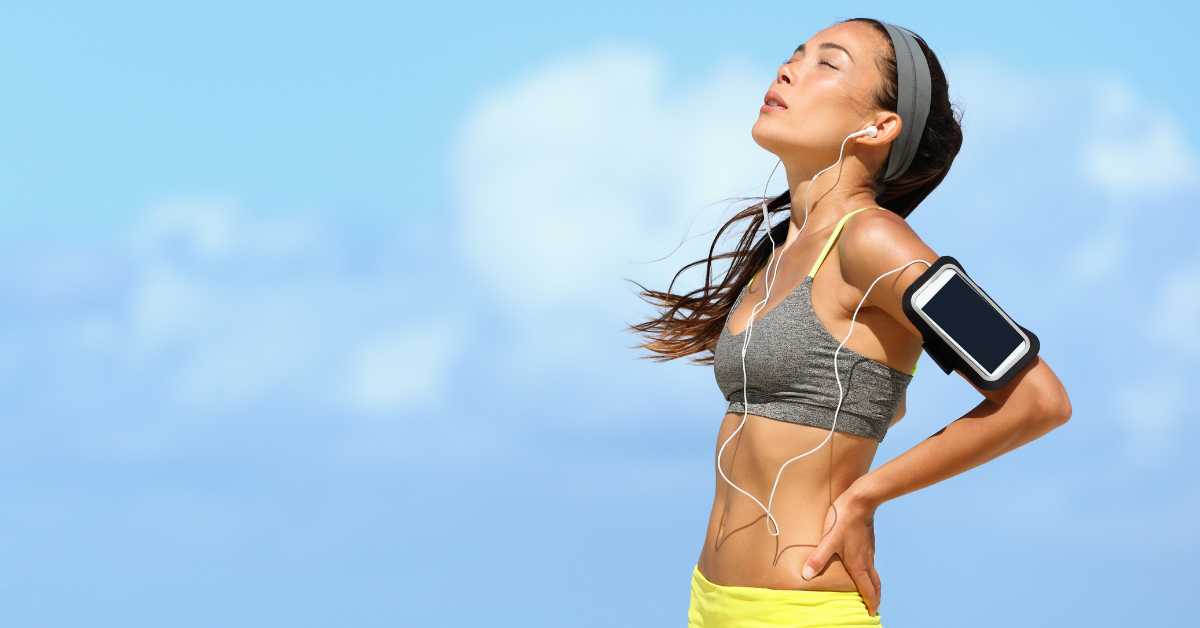 female stopping to catch her breath, Runner's Face: What It Is And 13 Ways To Avoid It. getty images