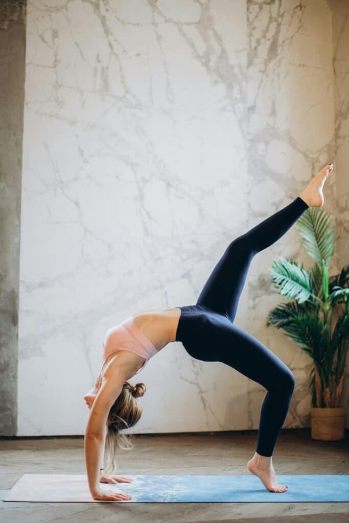 Fitness model doing a back bend. Exercise movement.