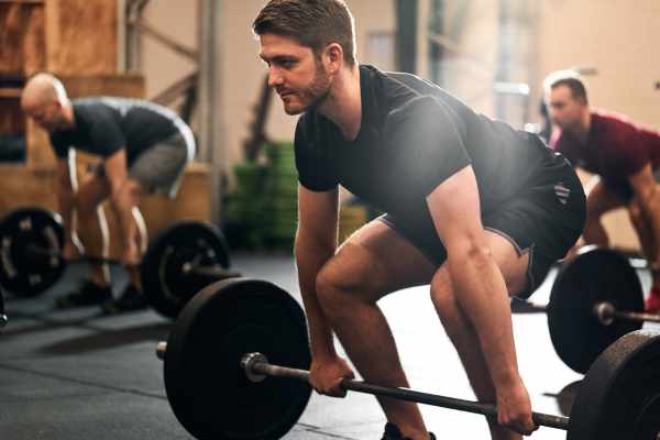 man performing dead lifts  weight training