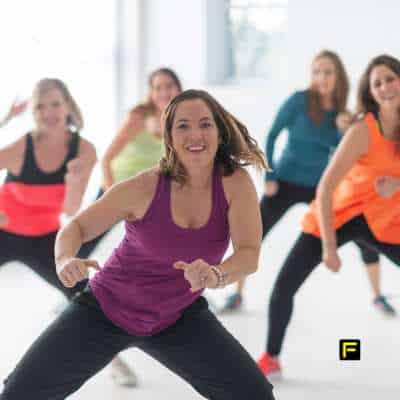 Group of women participating in a high-energy fitness class, showcasing strength, mobility, and the benefits of creatine for bone health and maintaining strong bones as they age.