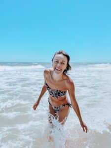 Woman playing in ocean.