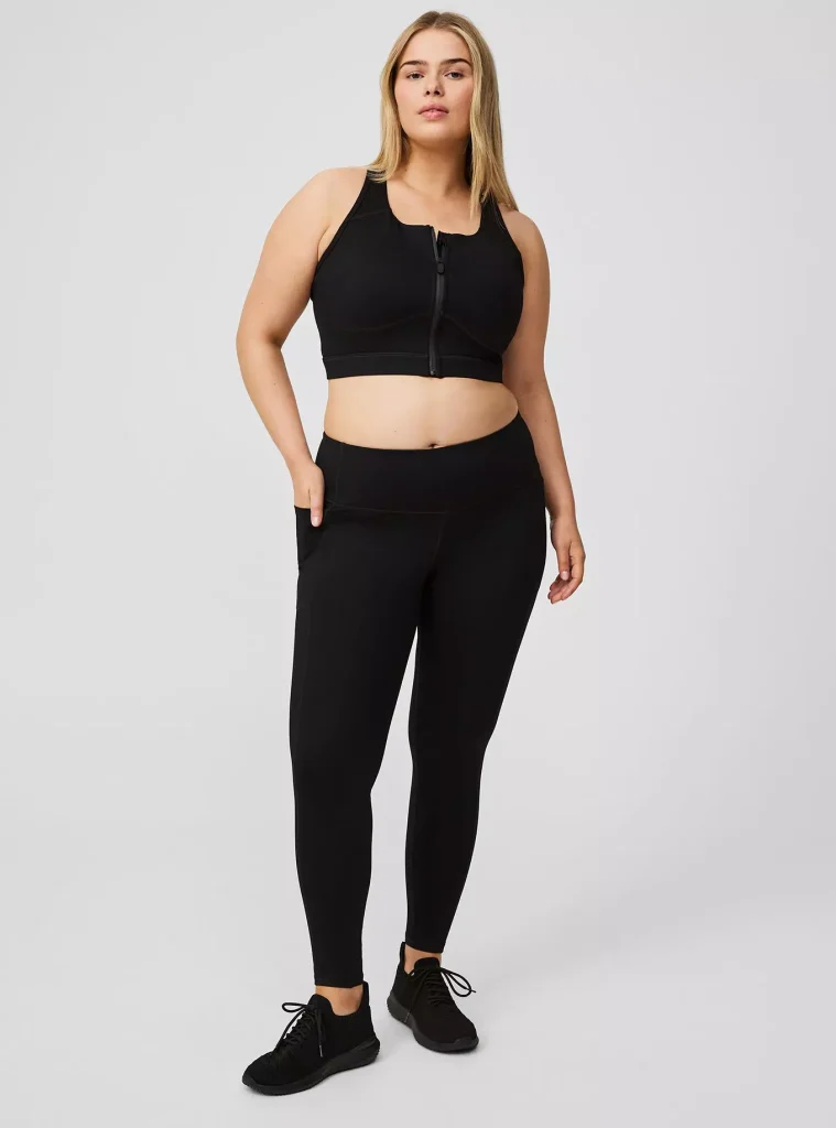 16 Best Workout Leggings for Plus Size Women Over 50 (2025) 14 Fitness model wearing zip tank top with Torrid Active Full Length Leggings With Pockets.