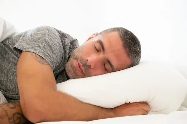 Best Cooling Pillow for Hot Sleepers: Say Goodbye to Night Sweats 3 cooling pillow recommendations. man sleeping on cooling pillows.