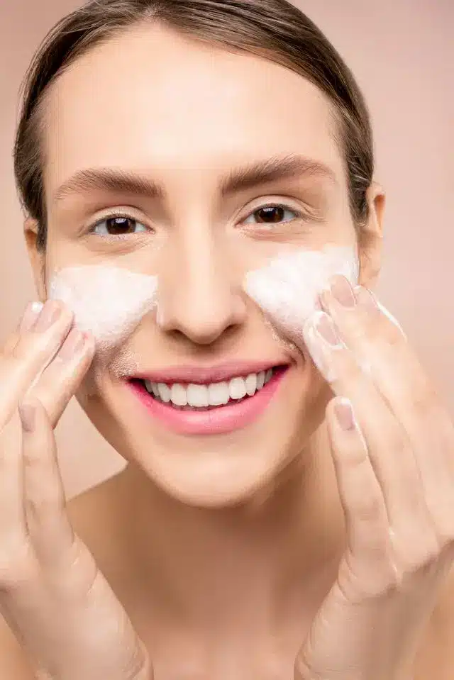 The Best Premium Face Wash for Women with Combination Skin (11 Cult-Favorite Picks) 3 Woman washing her face with a gentle foaming cleanser for combination skin