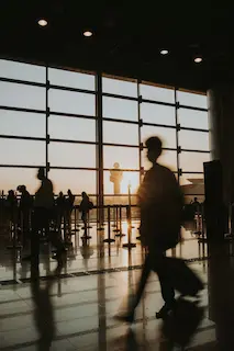 Best Air Tags for Seniors: 11 Trackers That Bring Peace of Mind Back Into Your Day 5 Woman walking in airport. Best air tags for older people.